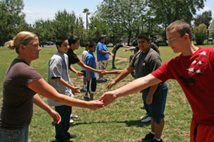 Kids on fields holding hands.